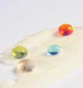 Droplets of water, motor oil, ethylene glycol and n-hexadecane solvent bead up on a superamphiphobic paper sample that has been prepared at the Georgia Institute of Technology.