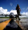 An Air Force pilot performs a pre-flight inspection of a "Hurricane Hunter" aircraft. Similar aircraft have begun measuring GPS signals bouncing off the ocean surface to determine wind speed.