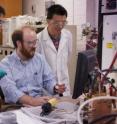 Michael Hickner, seated, along with research associates Yongjun Leng, left, and Nanwen Li review the data received from a specific polymer membrane that has been inserted into the fuel cell test stand.