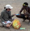 University of Pennsylvania psychologist Coren Apicella works with the Hadza people of Northern Tanzania. As one of the last hunter-gatherer societies on Earth, and with little to no contact with outsiders, the Hadza present a rare opportunity to investigate whether economic biases are innate or learned. 

Here, Apicella gives a participant a choice to trade one package of cookies for another. In similar experiments done in Western industrialized societies, a common bias known as the "endowment effect" causes participants to stick with whatever item they are given first, rather than to trade for another, far more often than would be expected if they were making a rational decision. The most isolated Hadza tribes traded close to the expected rate, while Hadza tribes who has more contact with tourists traded less often.