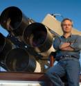 Los Alamos National Laboratory astrophysicist Tom Vestrand poses with a telescope array that is part of the RAPTOR (RAPid Telescopes for Optical Response) system. RAPTOR is an intelligent visual system that scans the skies for optical anomalies and zeroes in on them when it detects them. This unique capability allowed the system to witness the rare birth of a black hole in the constellation Leo recently.