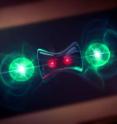 This is an artist's conception of a NIST experiment showing how quantum computing might benefit from lost information. Two beryllium ions (red), used as quantum bits or qubits to store information, were "entangled" so that their properties were linked -- a useful feature for quantum computing. Two partner magnesium ions (green) released heat to the environment. Any unwanted information in the qubits was coupled to the outgoing heat, leaving the qubits in the desired entangled state (suggested by the hourglass).