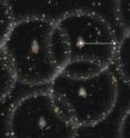 This is an artist's concept of the new measurement of the size of the Universe. The gray spheres show the pattern of the "baryon acoustic oscillations" from the early Universe. Galaxies today have a slight tendency to align on the spheres -- the alignment is greatly exaggerated in this illustration. By comparing the size of the spheres (white line) to the predicted value, astronomers can determine to one-percent accuracy how far away the galaxies are.