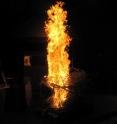 This image shows wildfire fuel being burned in the fire laboratory as the aerosols from the top are being sucked into inlets and sampled at the Missoula Fire Sciences Laboratory in Missoula, Montana by Los Alamos and Carnegie Mellon University scientists.
