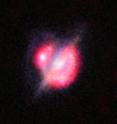 ALMA, the VLA, and other telescopes used gravitational lensing to obtain the best view yet of a collision that took place between two galaxies when the Universe was only half its current age. These new studies of the galaxy H-ATLAS J142935.3-002836 have shown that this complex and distant object looks surprisingly like the well-known local galaxy collision, the Antennae Galaxies. The foreground galaxy is doing the lensing and around it is an almost complete ring — the smeared out image of a star-forming galaxy merger far beyond. This picture combines the views from the Hubble Space Telescope and the Keck-II telescope on Hawaii (using adaptive optics) along with the ALMA images shown in red. The ALMA data also give information about the motions of the material in the distant merging galaxies and were vital in unravelling the complex object.