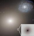 This Hubble Space telescope image shows the gargantuan galaxy M60 in the center, and the ultracompact dwarf galaxy M60-UCD1 below it and to the right, and also enlarged as an inset. A new international study led by University of Utah astronomer Anil Seth and published in the journal Nature found that M60-UCD1 is the smallest known galaxy with a supermassive black hole at its center, suggesting the dwarf galaxy originally was much larger but was stripped of its outer layers by gravity from galaxy M60 over billions of years. M60's gravity also is pulling galaxy NGC4647, upper right, and the two eventually will collide. (NOTE: for a version of this photo with the galaxy names labeled, email <a href="mailto:lee.siegel@utah.edu">lee.siegel@utah.edu</a>.)