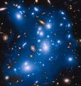 Massive galaxy cluster Abell 2744, nicknamed Pandora's Cluster, takes on a ghostly look where total starlight has been artificially colored blue in this Hubble view.