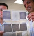 University of Utah graduate student Andrew Paulsen, left, and U electrical and computer engineering professor Ajay Nahata hold up a series of terahertz frequency filters made through a process they developed with an inkjet printer. They have discovered a new approach for designing filters capable of separating different frequencies in the terahertz spectrum, the next generation of communications bandwidth that could allow cell-phone users and Internet surfers to download data a thousand times faster than today. University of Utah graduate student Andrew Paulsen, left, and U electrical and computer engineering professor Ajay Nahata hold up a series of terahertz frequency filters made through a process they developed with an inkjet printer. They have discovered a new approach for designing filters capable of separating different frequencies in the terahertz spectrum, the next generation of communications bandwidth that could allow cell-phone users and Internet surfers to download data a thousand times faster than today.