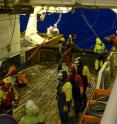 University of New Hampshire geologist Joel Johnson (center, with beard) prepares to collect seismic data on board the research vessel Helmer Hanssen in the Fram Strait.