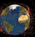 The spreading of the fragmentation cloud to form a band of debris (exaggerated size).