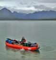 Biologist Sean Brennan paddles his equipment-laden kayak during a study that developed a new way to use strontium isotope ratios in 'fish ear bones' of chinook salmon caught at sea to identify in what streams within Alaska's Nushagak River watershed the fish hatched and lived before migrating to Bristol Bay and the Pacific. Brennan, a University of Utah biology graduate, did the study as a doctoral student at the University of Alaska Fairbanks and performed the lab work in Utah. He now is a postdoctoral researcher at the University of Washington.