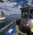 Scientists in the UC Davis Tahoe Environmental Research Center's research vessel check on a NASA-JPL research buoy that collects data about Lake Tahoe.