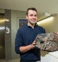 Dr. Rhodri Davies is pictured with volcanic rock. Dr. Rhodri Davies is pictured with volcanic rock.