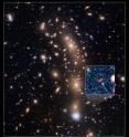 This is a Hubble Space Telescope view of a very massive cluster of galaxies, MACS J0416.1-2403, located roughly 4 billion light-years away and weighing as much as a million billion suns. The inset is an image of an extremely faint and distant galaxy that existed only 400 million years after the big bang. Hubble captured it because the gravitational lens makes the galaxy appear 20 times brighter than normal. This is a Hubble Space Telescope view of a very massive cluster of galaxies, MACS J0416.1-2403, located roughly 4 billion light-years away and weighing as much as a million billion suns. The inset is an image of an extremely faint and distant galaxy that existed only 400 million years after the big bang. Hubble captured it because the gravitational lens makes the galaxy appear 20 times brighter than normal.